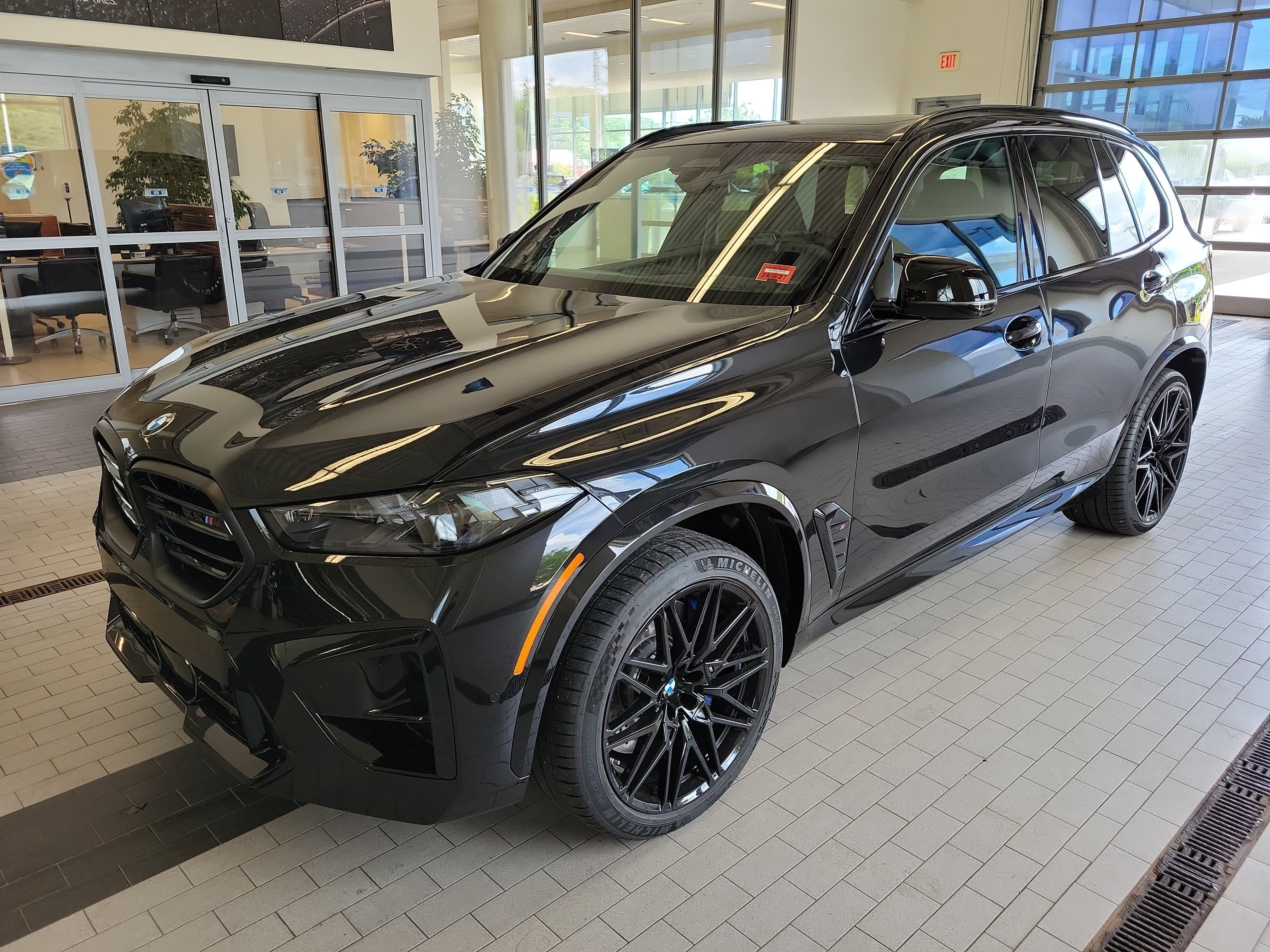 2026 BMW X5 M Competition in Black Sapphire Metallic — front three-quarter view